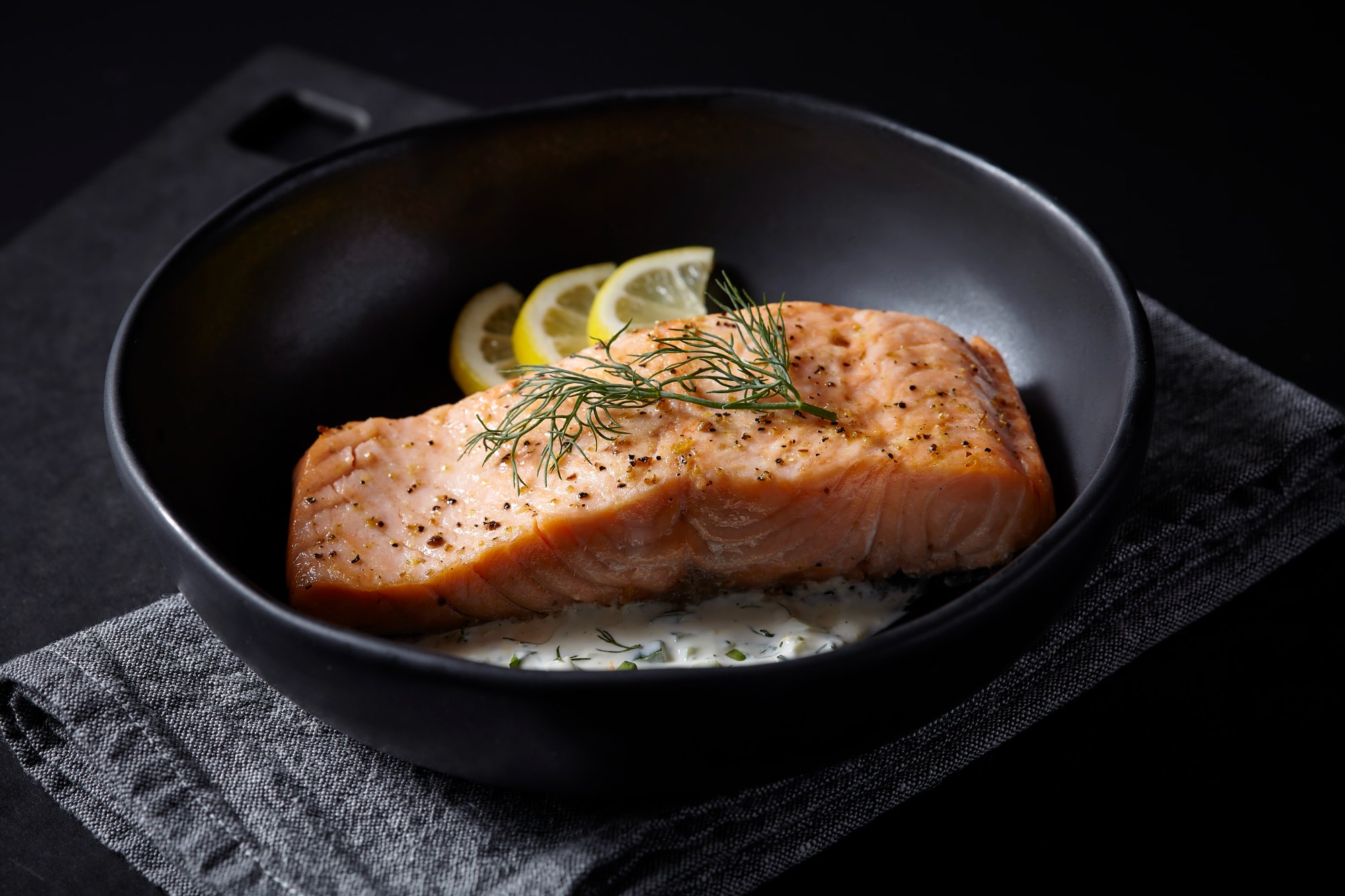 Commercial food photography — salmon with cucumber lemon dill sauce
